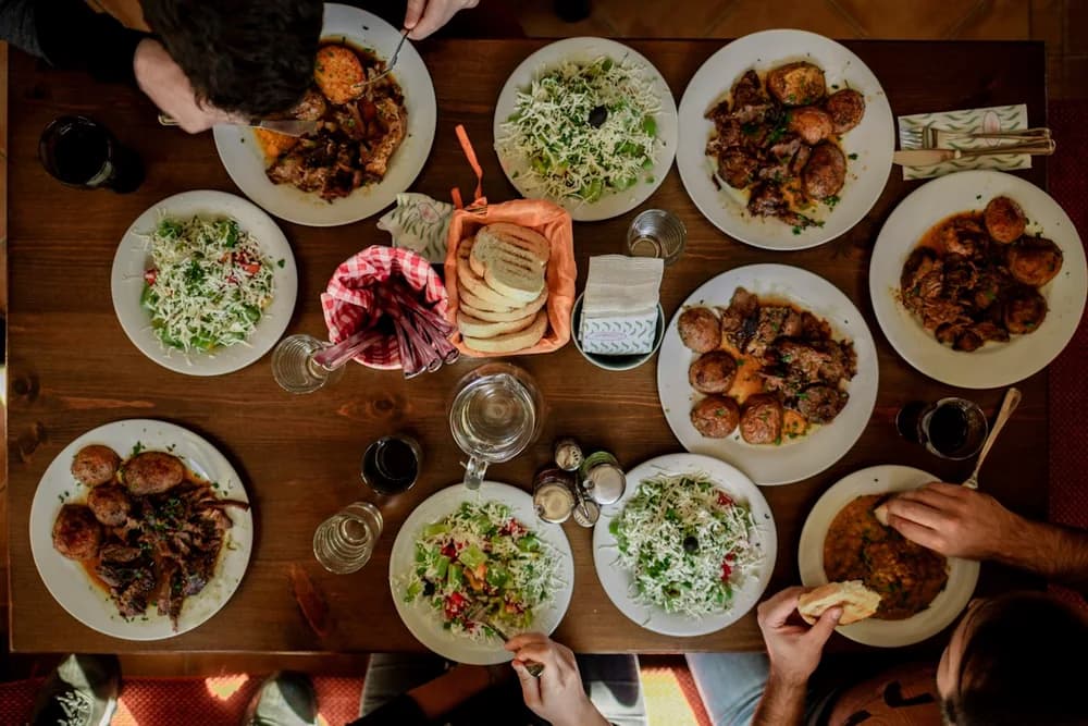 A shared table filled with dinner plates