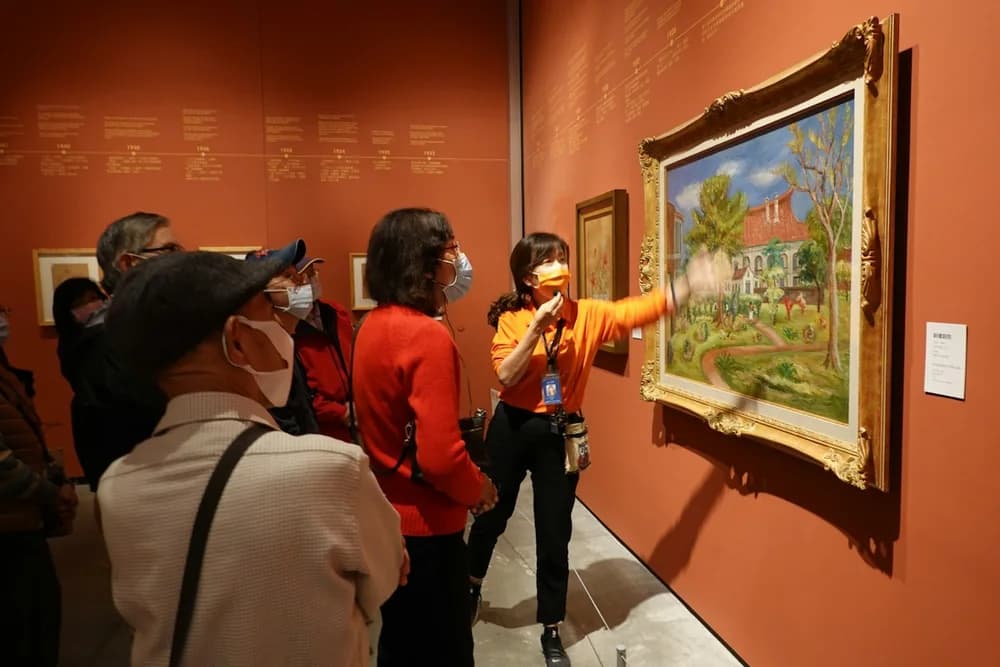 Visitors looking at a painting with a museum guide